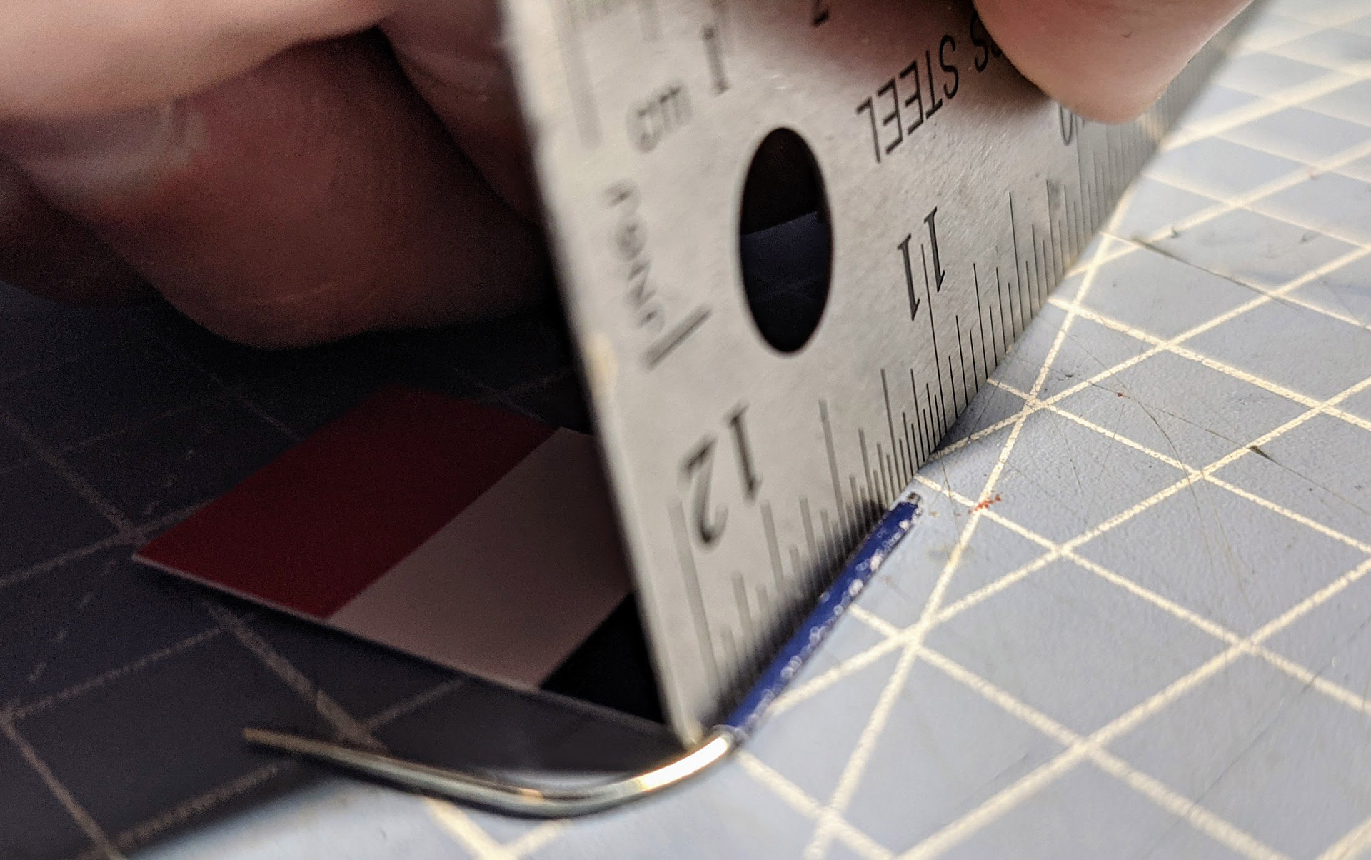 Use a ruler to form a crease in next to the paperclip. 